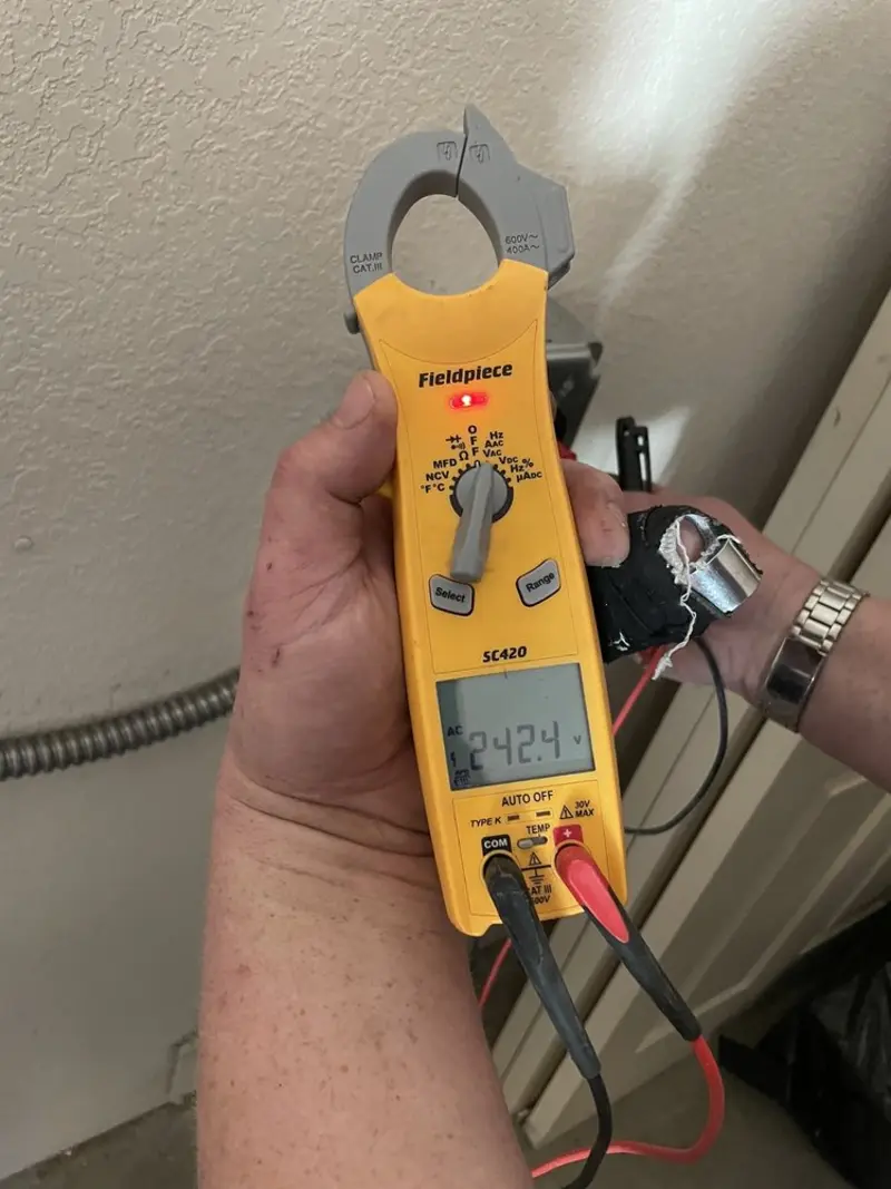 Voltage testing with clamp meter during Recessed Lighting Installation in Casco